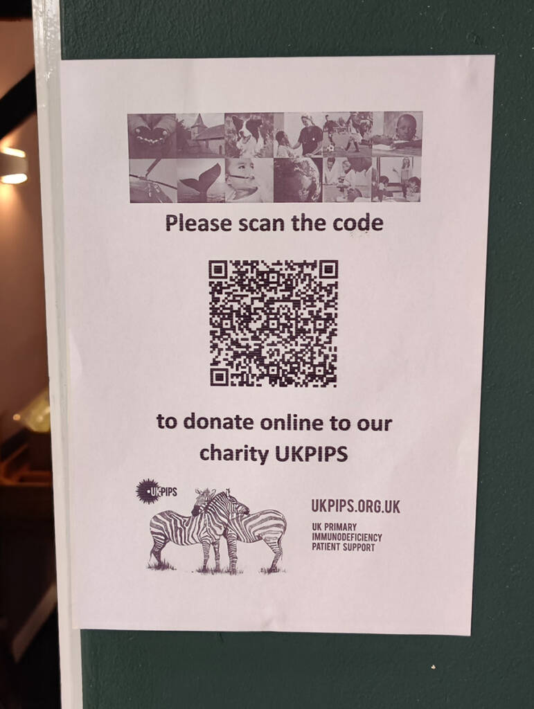 One of several posters featuring a QR code for online donations
