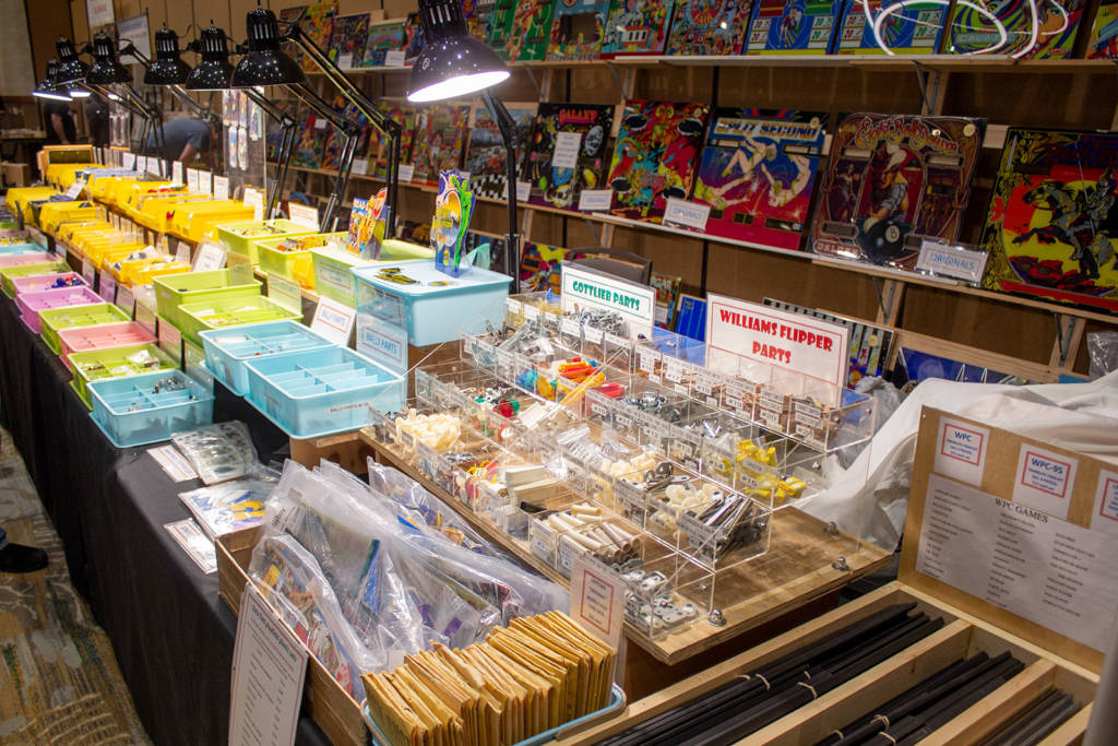The Mayfair Amusement Co. had a large stand of assorted pinball parts, backglasses, flyers and documentation