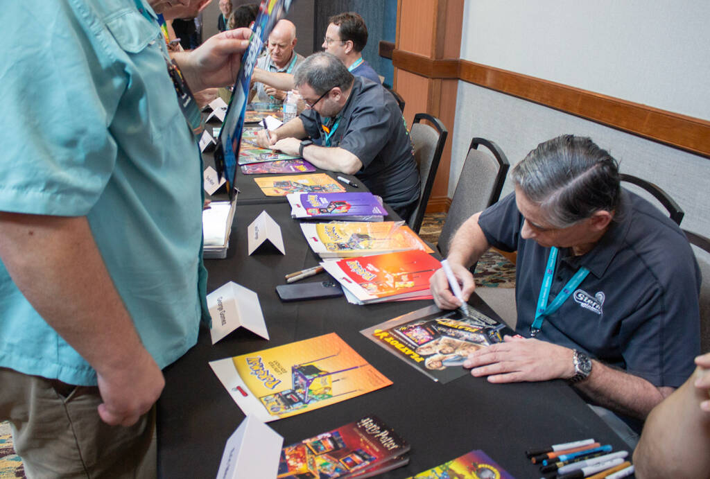 George Gomez was kept busy signing assorted items