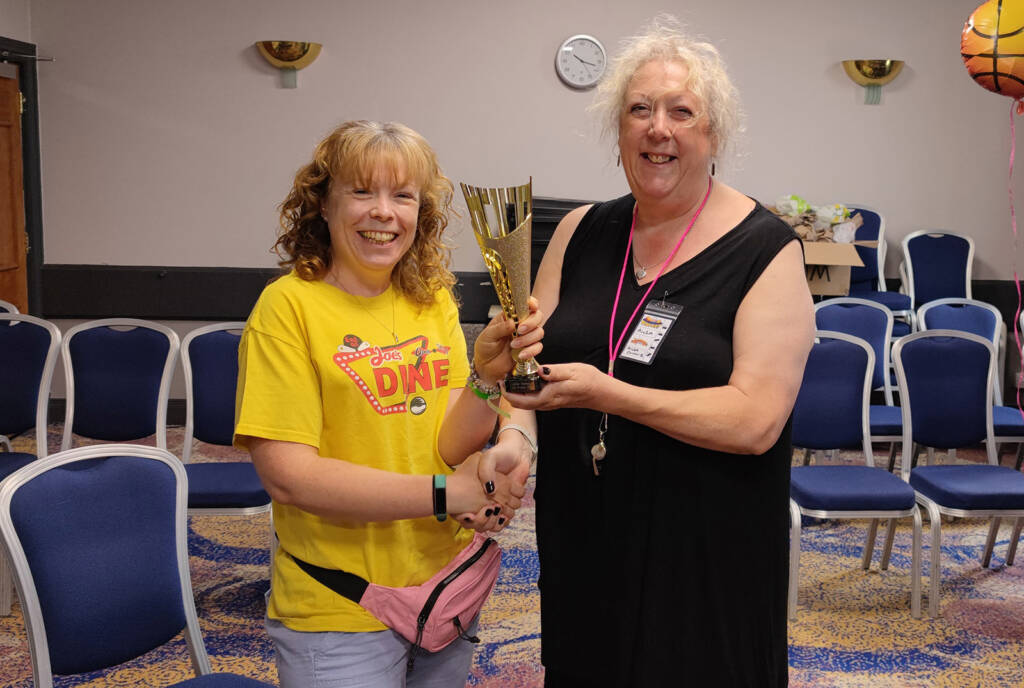 Sarah Vince receives her trophy from Ailsa Clunie of the Scottish Pinball Association