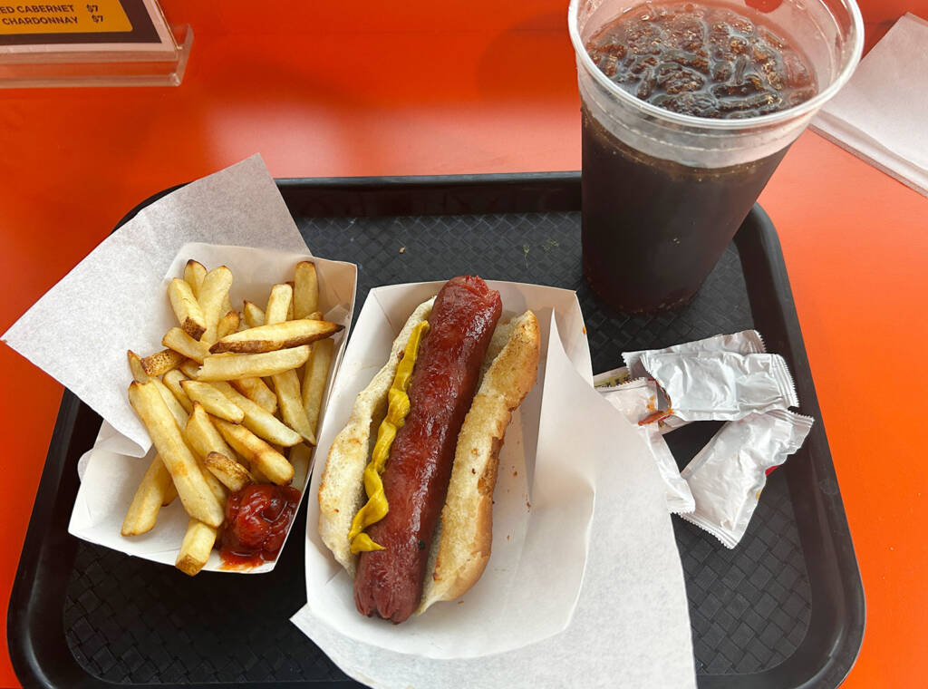 The freshly prepared jumbo dog and french-fries were served too hot to eat at first
(Author’s Note: We know we tried - notice the split end of the dog and partially consumed soda)
