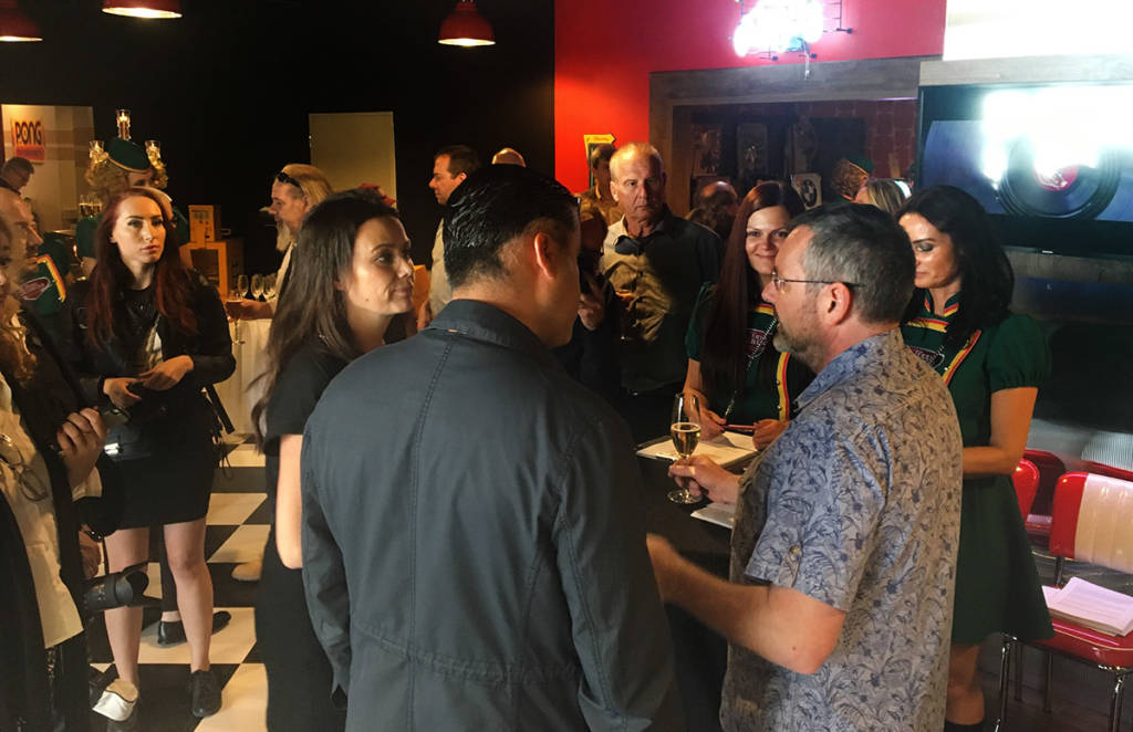 Party guests chat with Terra Technica owner, Ronald Seunig, in the museum's entrance