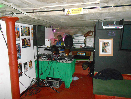 Another DJ gets ready for their set downstairs