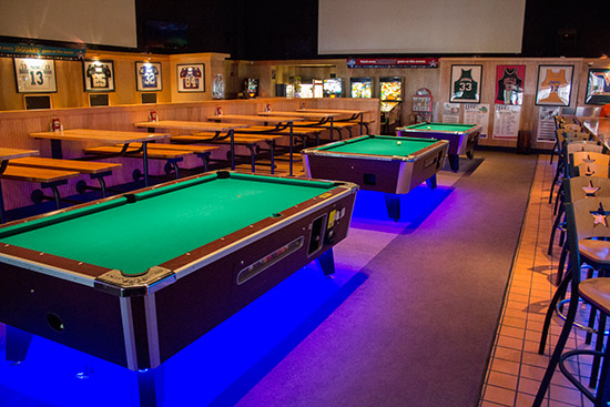 The pinball machines are at the back of the bar, behind the pool tables